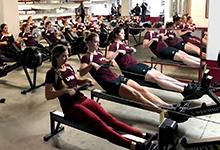 SPU's women's rowing team practicing on their rowing machines.