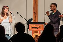 Two singers from SPU's praise and worship band perform at chapel on the road.